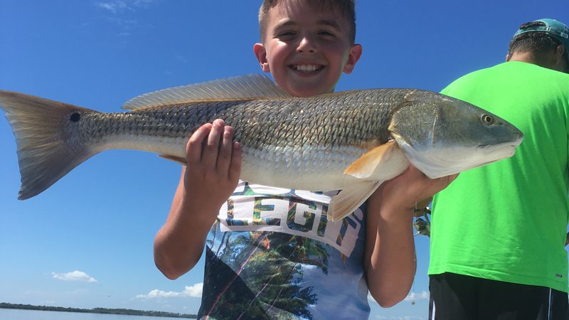 Family fishing charter in New Smyrna Beach, kid-friendly inshore trip on calm protected water